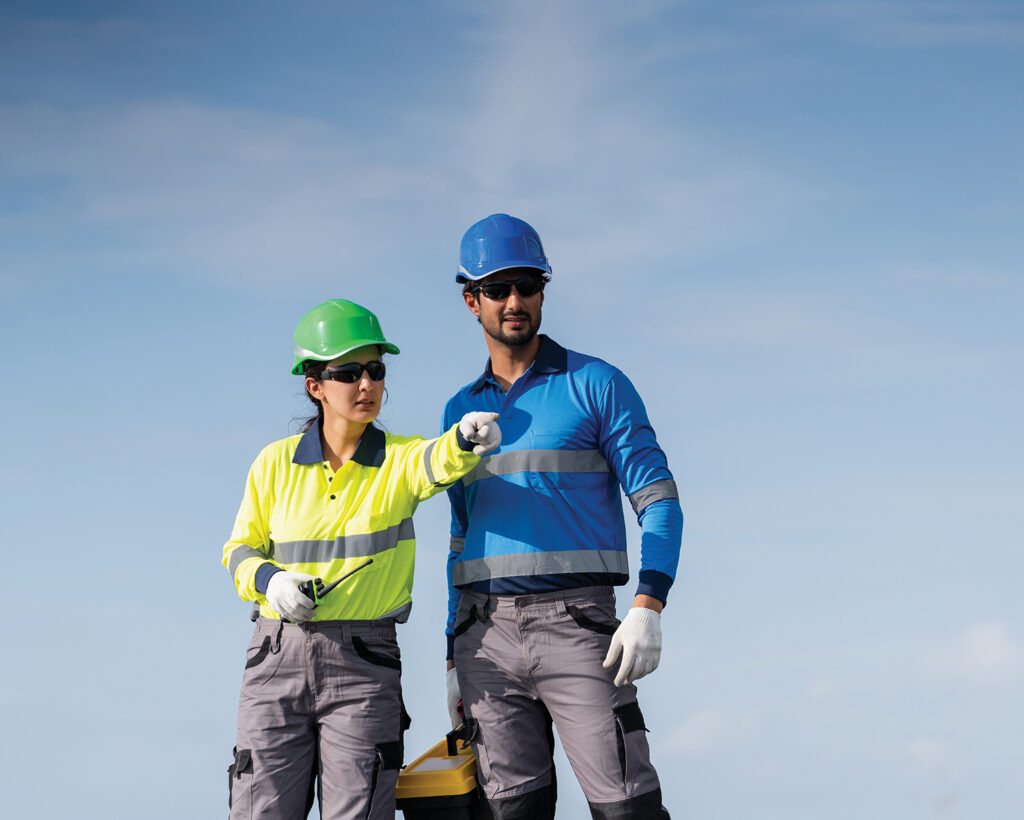 A service engineer is inspecting rooftop solar panels for maintenance and checking for any damaged parts. The technician is also involved in installing solar panels, promoting the use of clean energy.